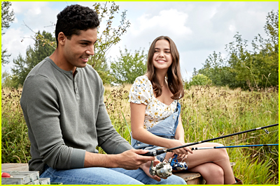 Michael Evans Behling and Bailee Madison sit in a field in 'A Cinderella Story: Starstruck'