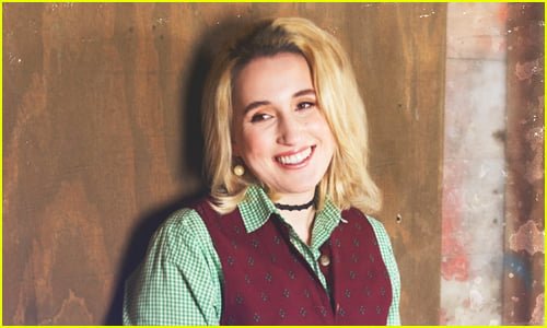 Harley Quinn Smith smiles to someone off to the side of the camera 