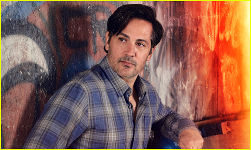 Michael Landes looks off to the side in a flannel shirt