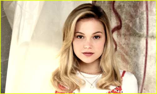 Olivia Holt looks at the camera with her hair down