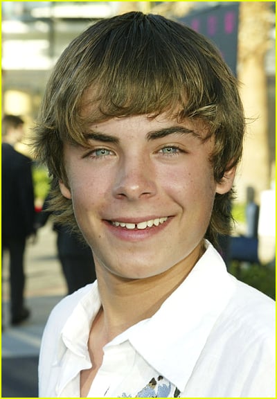 Zac Efron Smiles while wearing a white shirt