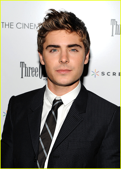 Zac Efron wears a black suit to a red carpet event