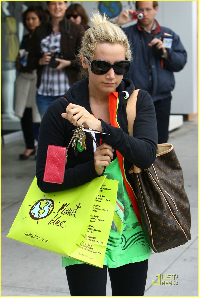 Ashley Tisdale carrying a Louis Vuitton shopping bag while out