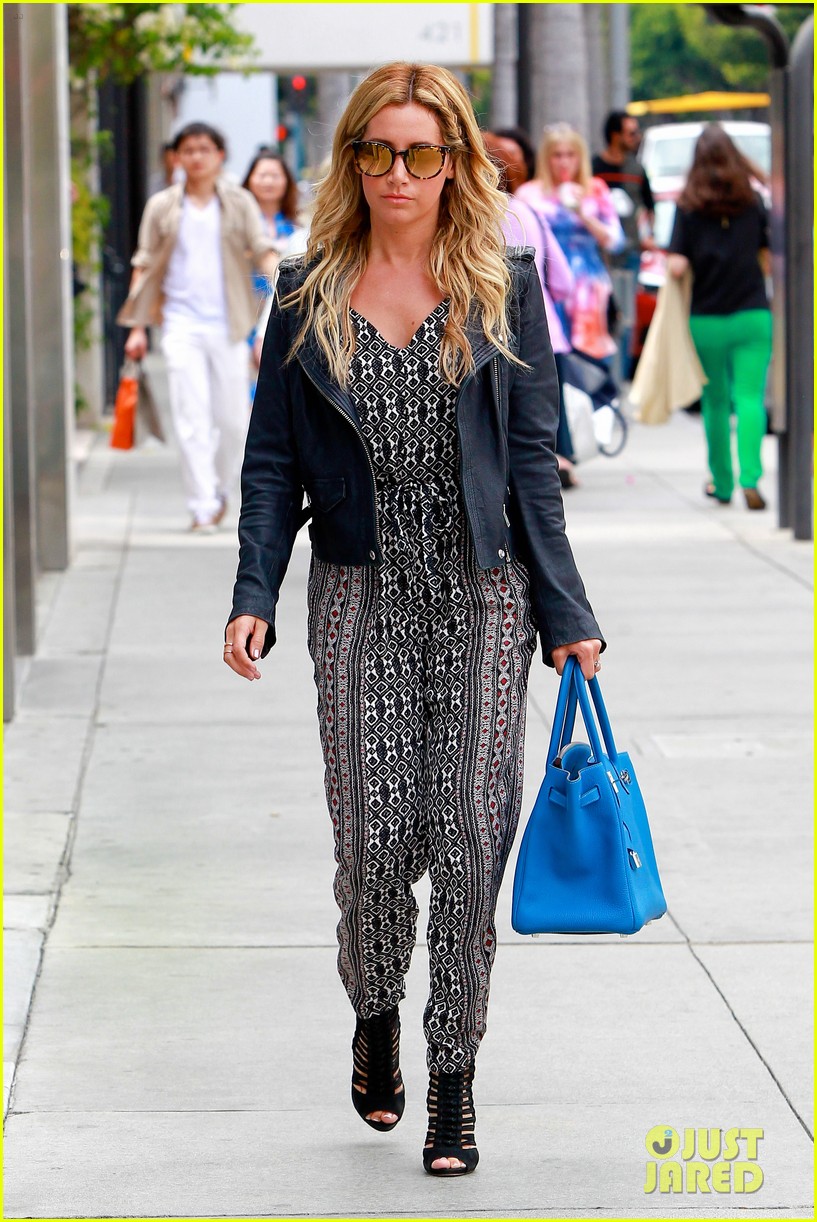 Ashley Tisdale carrying a Louis Vuitton shopping bag while out