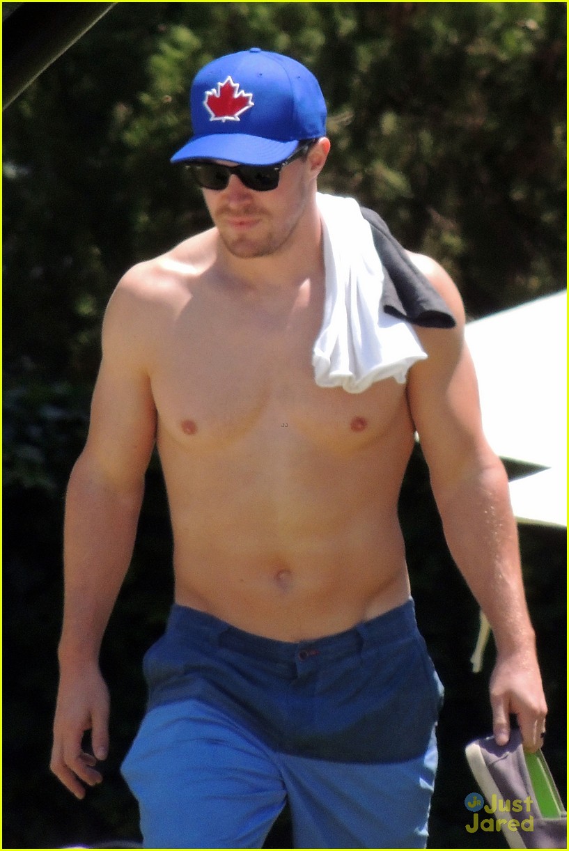 Stephen Amell puts his muscular body on display while going shirtless by th...