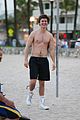 ansel elgort goes shirtless for a workout at the beach 01