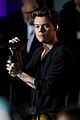 harry styles looks stylish while performing new songs from debut album 10