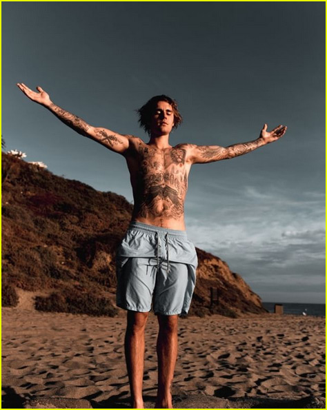 justin bieber shows off tattoos posing shirtless on the beach 01