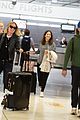 elle fanning and olivia wilde share a laugh at jfk airport with jason sudeikis02