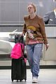 elle fanning and olivia wilde share a laugh at jfk airport with jason sudeikis06