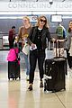 elle fanning and olivia wilde share a laugh at jfk airport with jason sudeikis07