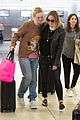 elle fanning and olivia wilde share a laugh at jfk airport with jason sudeikis08