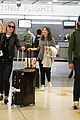 elle fanning and olivia wilde share a laugh at jfk airport with jason sudeikis09
