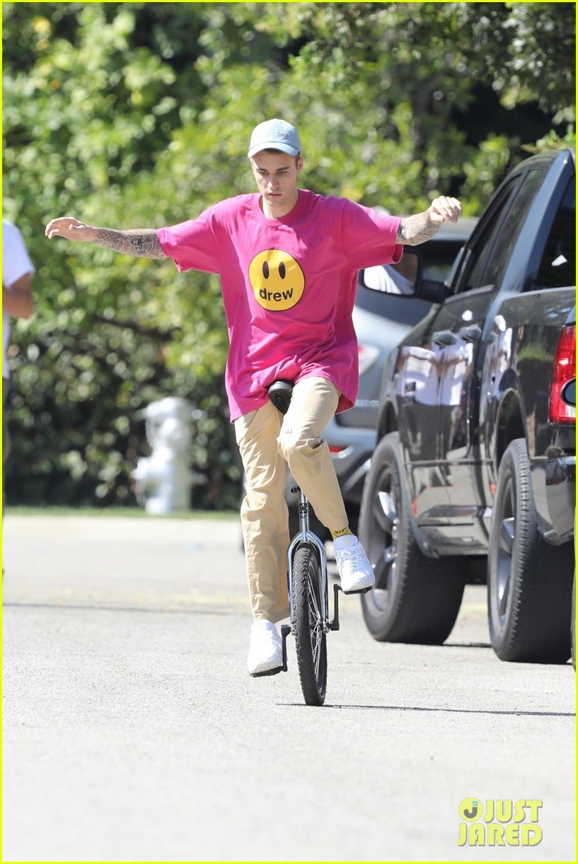 Full Sized Photo of justin bieber falls off unicycle while learning how ...