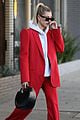 hailey bieber red suit dog ruins tree 02