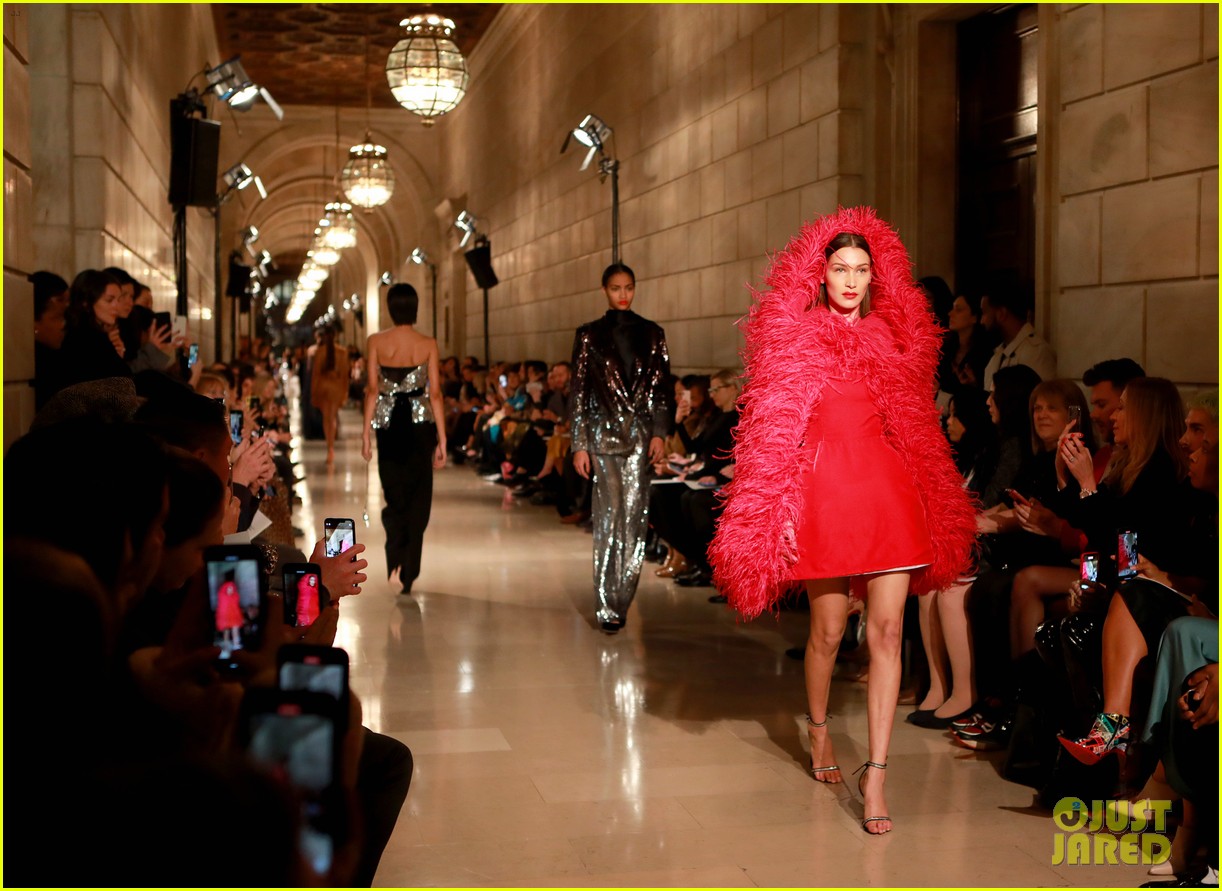 Bella Hadid Wears Red, Feathered Hooded Jacket For Oscar de la Renta ...