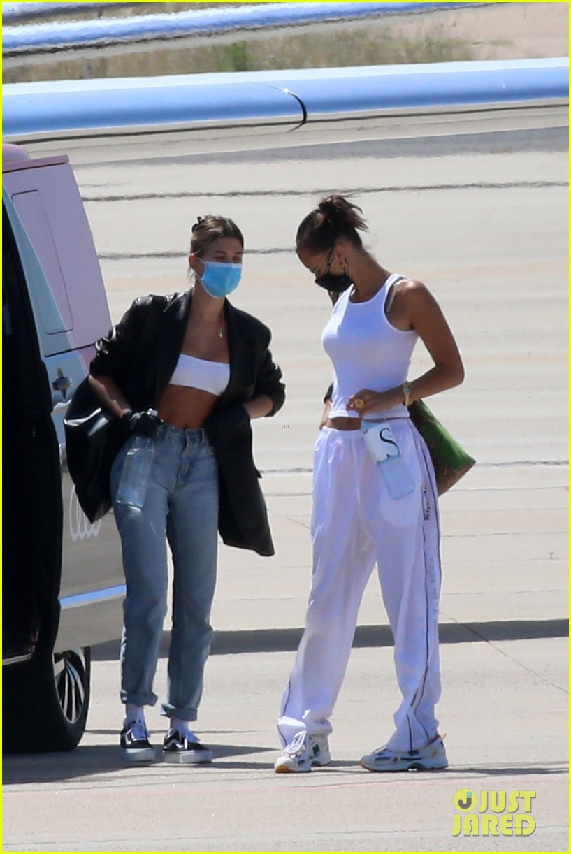 Full Sized Photo of hailey bieber bella hadid fly home from sardinia 22 ...