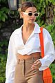hailey bieber shows of toned midriff for business meeting 02