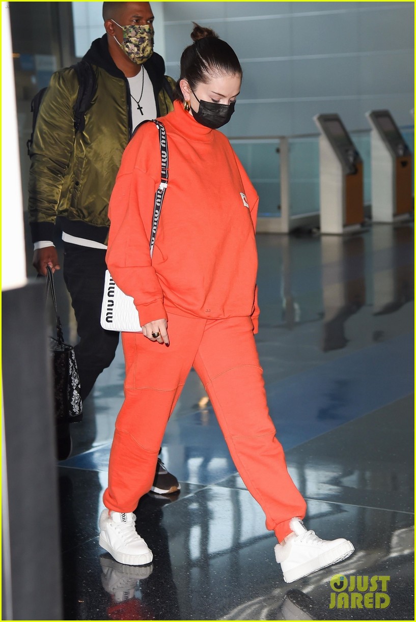 selena gomez orange tracksuit airport arrival 04