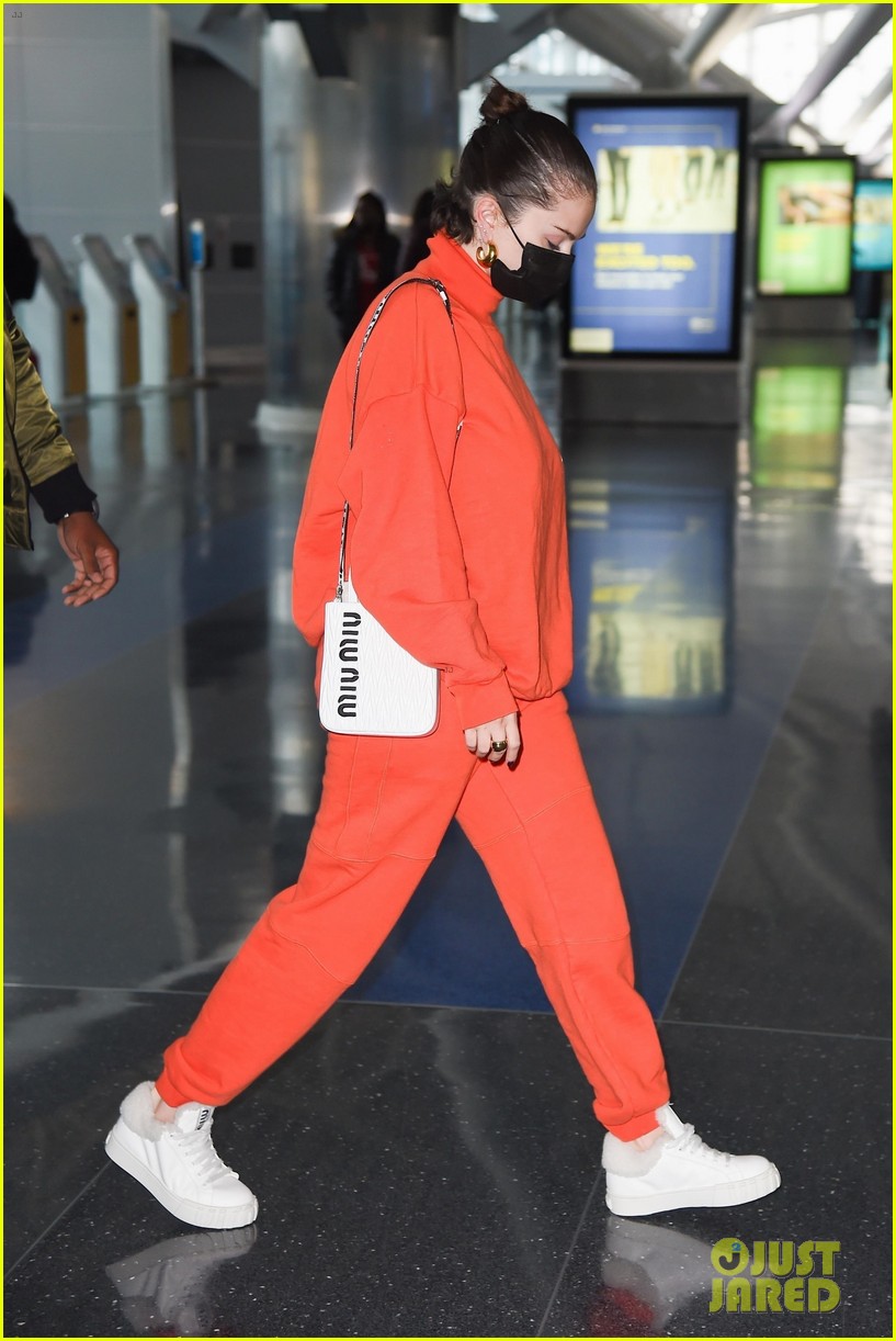 selena gomez orange tracksuit airport arrival 05