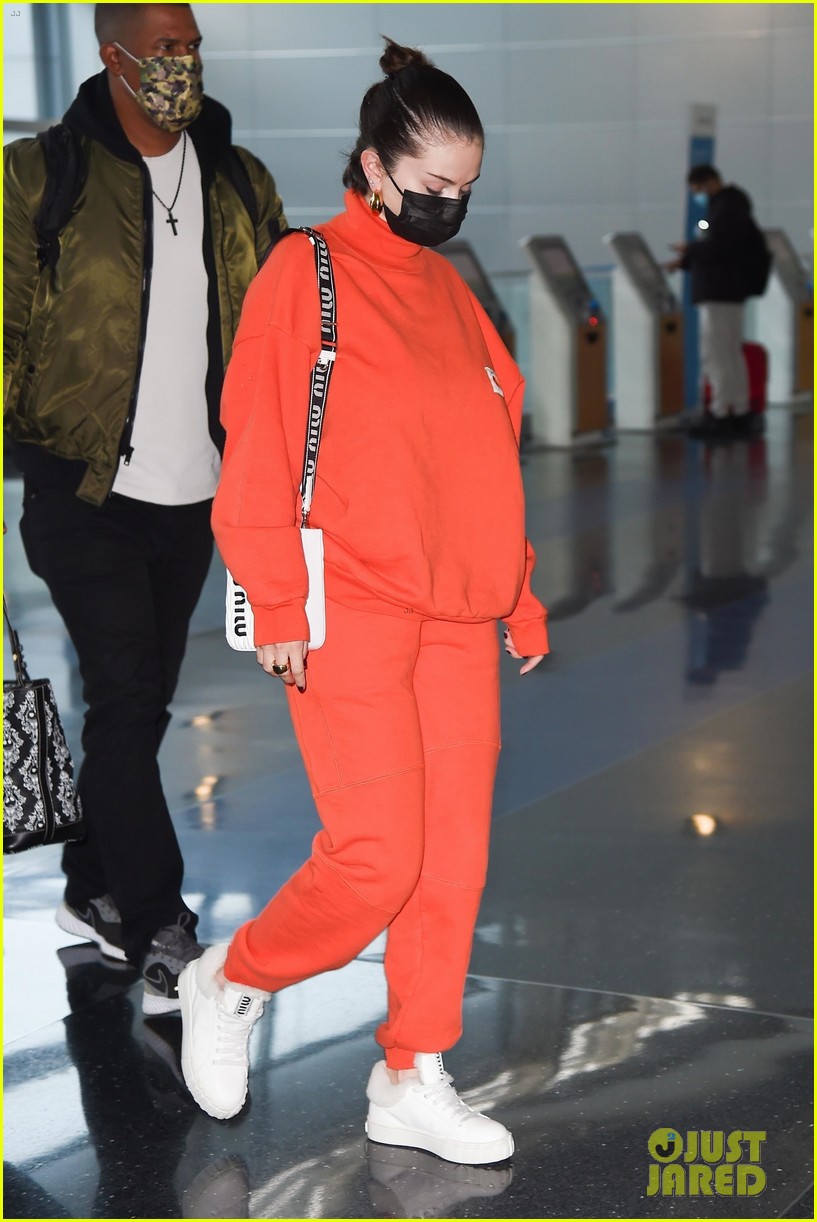 selena gomez orange tracksuit airport arrival 16