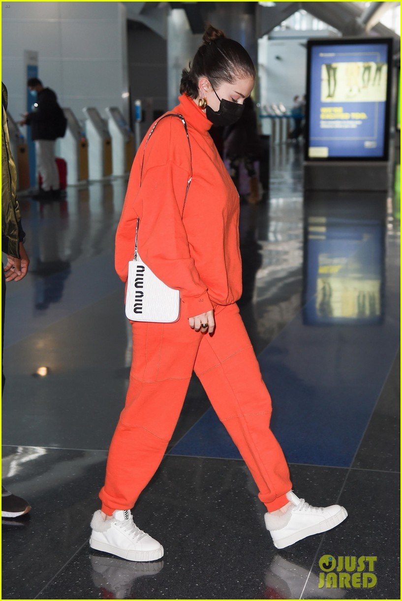 selena gomez orange tracksuit airport arrival 20