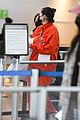 selena gomez orange tracksuit airport arrival 11