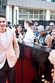 hero fiennes tiffin joins costars at woman king tiff premiere 09