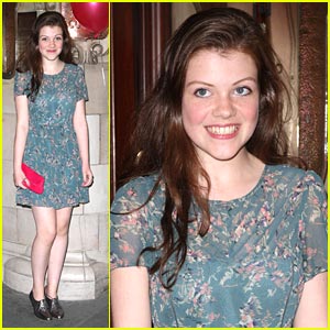 Georgie Henley adds a splash of color with her clutch as she attends press ...