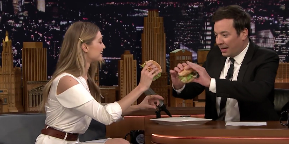 Gigi Hadid and Jimmy Fallon eat hamburgers during Tonight Show