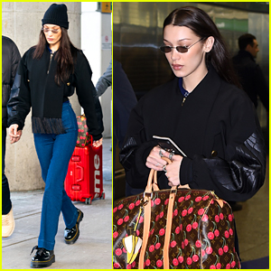 bella hadid carries her louis vuitton and chanel bags as she steps