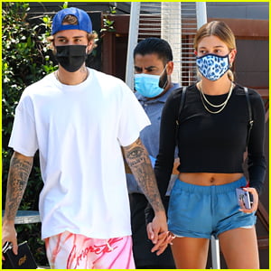 Justin Bieber holds his pants at lunch while Hailey Bieber rocks