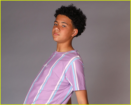 Jalon Christian leans back in striped shirt for photo shoot